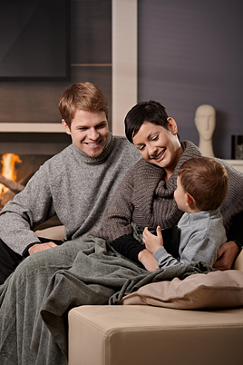 family cozy on couch