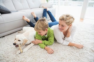 mother and son playing with dog