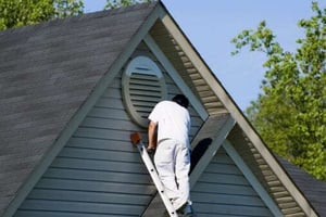 man painting house