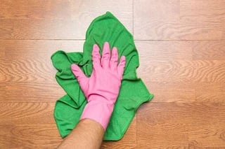 person cleaning wood floor
