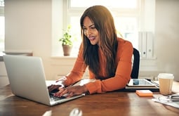 woman reading about home plumbing on laptop