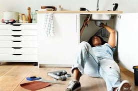 woman fixing sink