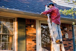 Man Cleaning Gutter