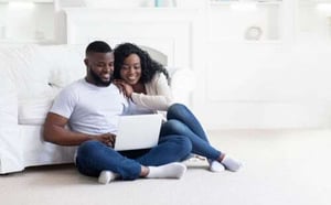 couple looking at house plans on laptop