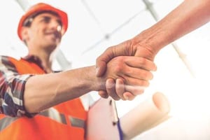 contractor shaking hands with client