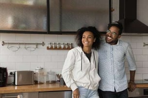 couple smiling in new house