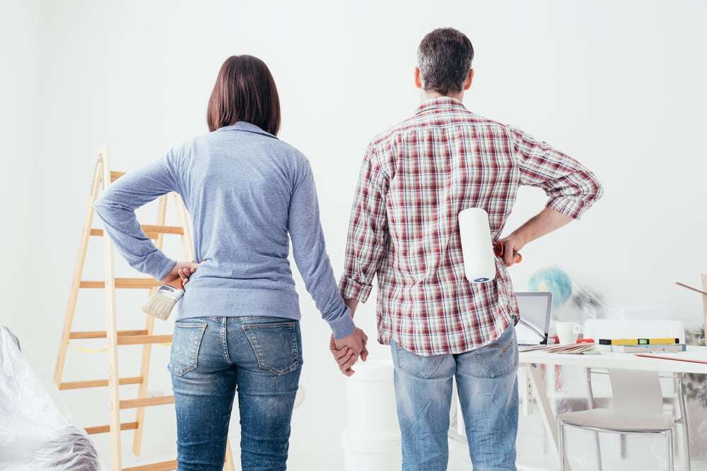 couple staring at freshly painted room shutterstock_704540374