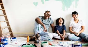 family renovating home and smiling