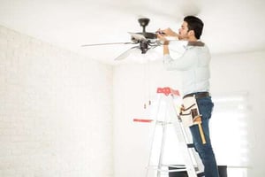 man installing ceiling fan