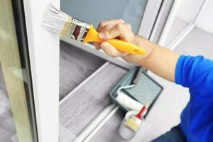 man painting a house exterior