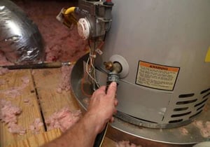 person performing water heater maintenance