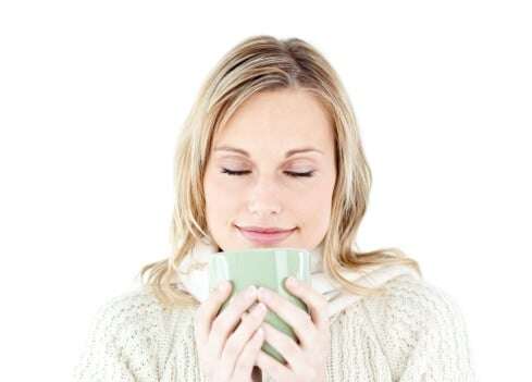woman_in_sweater_with_coffee_mug_feeling_just_right