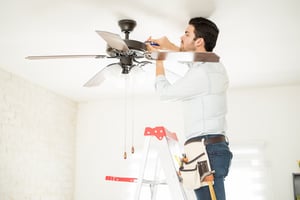 electrician installing ceiling fan